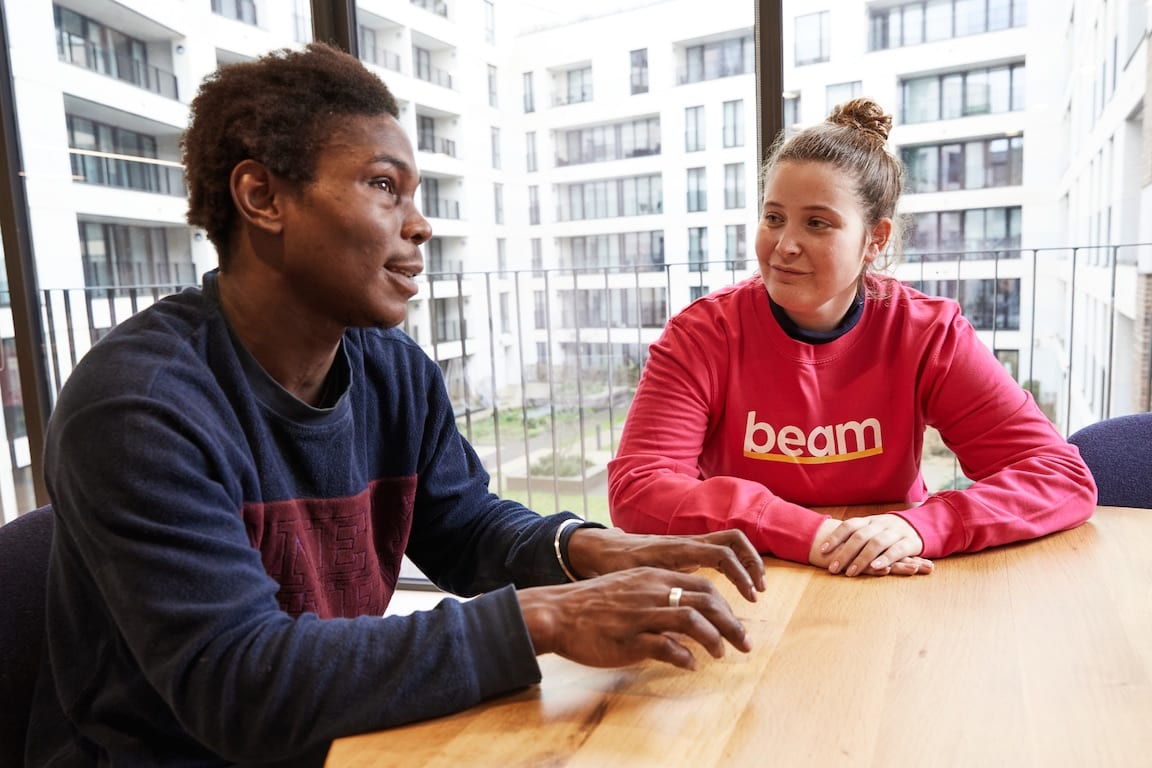 Man talking with Beam team at Beam office